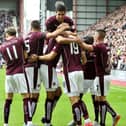 Hearts players surround Juanma Delgado after scoring against St Johnstone on the opening day of the 2015/16 Scottish Premiership season.