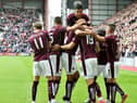 Hearts players surround Juanma Delgado after scoring against St Johnstone on the opening day of the 2015/16 Scottish Premiership season.
