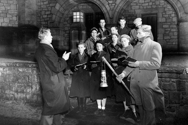 Carol singers rehearsing outside Reid Memorial Church Edinburgh in December, 1955, conducted by Rev IM MacGregor.