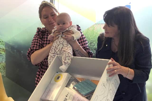 Courtney McLeod and her four-month-old daughter Addison meet Children's minister Clare Haughey at APS (Group) Scotland in Edinburgh, with a baby box which is delivered to the mother of every new born baby a few weeks before their due date