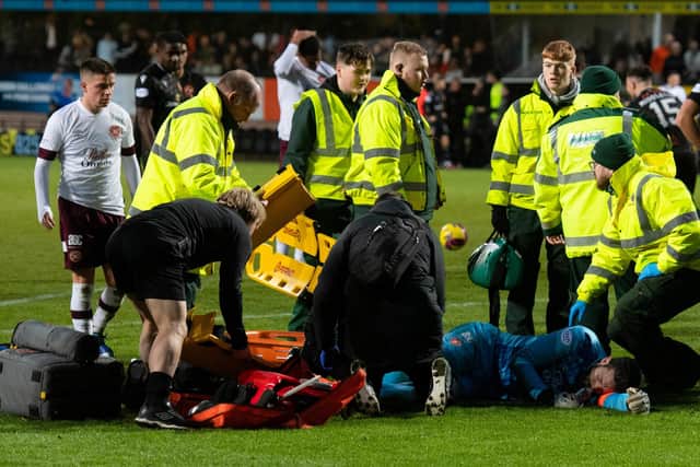 Medics attend to Hearts goalkeeper Craig Gordon after the Scottish international sustained an injury in a collision with Steven Fletcher. Cammy Devlin, top left, watches on. Picture: SNS