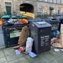Rubbish piled up outside bins in the bity