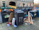 Rubbish piled up outside bins in the bity