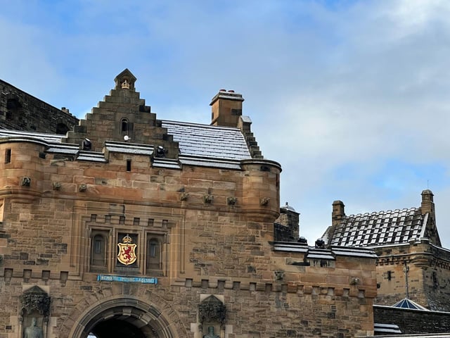 Snow dusted the roof-tops of Edinburgh Castle, above the city's coat of arms.