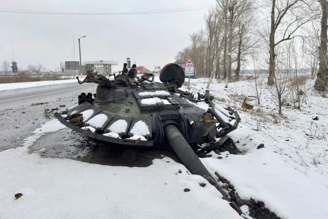 The gun turret of a destroyed Russian tank lies on the road near the city of Kharkiv, which has come under heavy attack by Vladimir Putin's finances (Picture: Sergey Bobok/AFP via Getty Images)