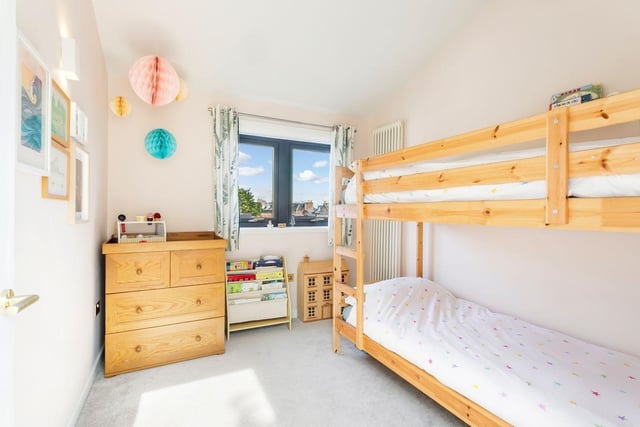 Another of the property's three bedrooms. All fitted floor and window coverings, light fittings, integrated kitchen appliances (five-burner gas hob and an oven/grill) a fridge/freezer, a dishwasher, and a washing machine are to be included in the sale