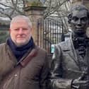 Angus Robertson beside the statue of Edinburgh poet Robert Fergusson