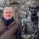 Angus Robertson beside the statue of Edinburgh poet Robert Fergusson