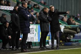 Motherwell manager Graham Alexander speaks to fourth official Andrew Dallas during his side's 1-1 draw with Hibs at Easter Road. Picture: SNS