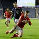 Wales' Louis Rees-Zammit dives over to score his side's fourth and decisive try at BT Murrayfield Stadium. Picture: Jane Barlow/PA