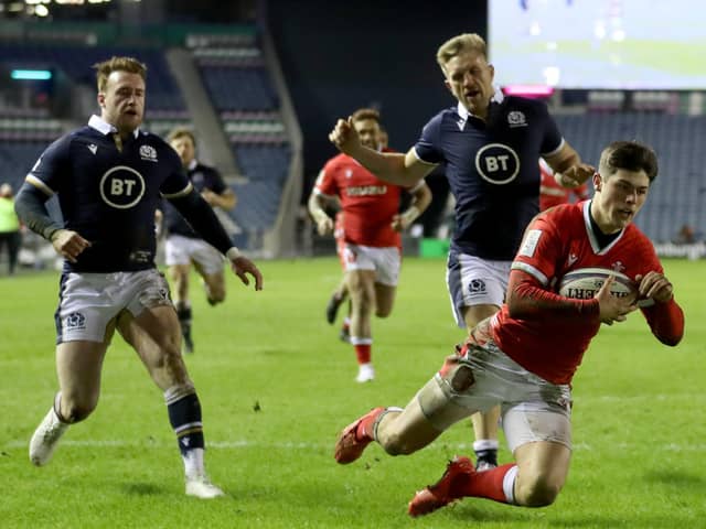 Wales' Louis Rees-Zammit dives over to score his side's fourth and decisive try at BT Murrayfield Stadium. Picture: Jane Barlow/PA