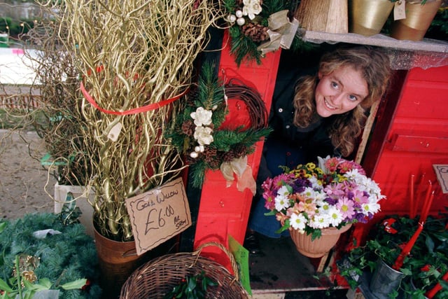 Pippa Jones emerges from the Honeysuckle Florist stand at the Christmas Market in Princes Street Gardens, in 1998.