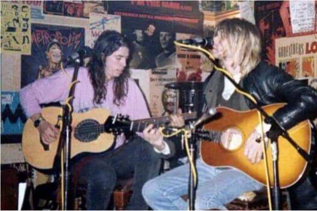 Left, Dave Grohl, and right, Kurt Cobain as the Nirvana pair perform an acoustic set at the Southern Bar in Edinburgh in 1991.