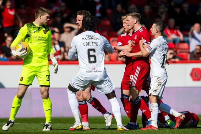 Max Stryjek clashes with Aberdeen's Lewis Ferguson after the Livingston goalkeeper appeared to slap Dons attacker Vicente Besuijen.