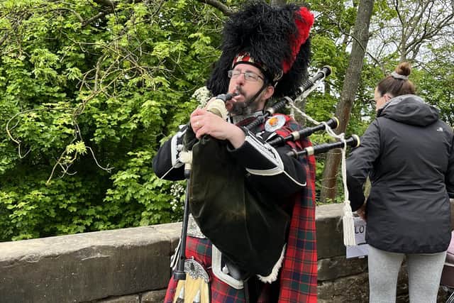 On the bridge, local piper Rab Reid competed with the choir to welcome the flotilla!