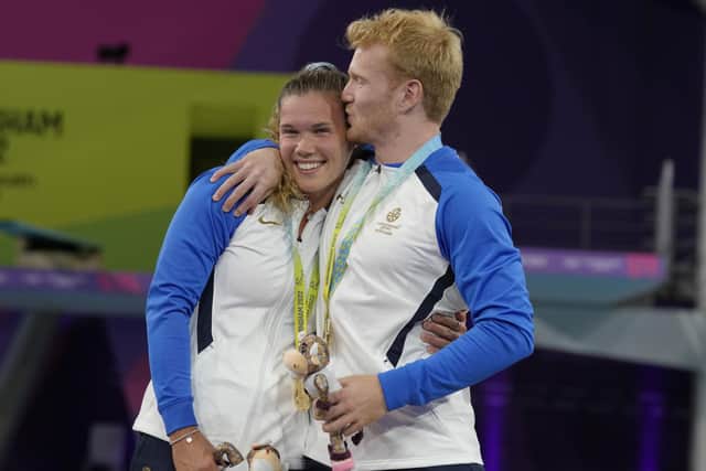 James Heatly, right, and Grace Reid embrace as they pose with their gold medals. Picture: Kirsty Wigglesworth / AP