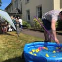 Senior carer Sam and daughter Farrah play hook a duck at the Drummond Summer Fete.