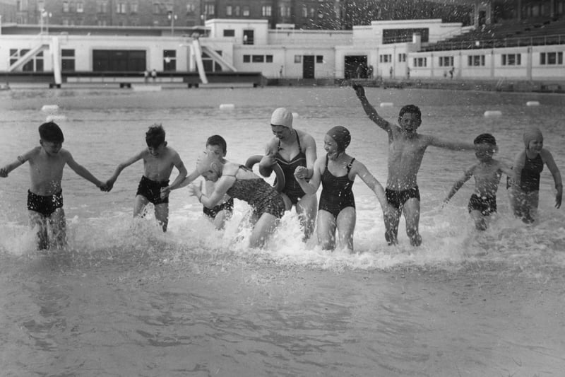 Children keeping cool in the summer sun by paddling in Portobello Outdoor Pool, sometime in the 1960s.