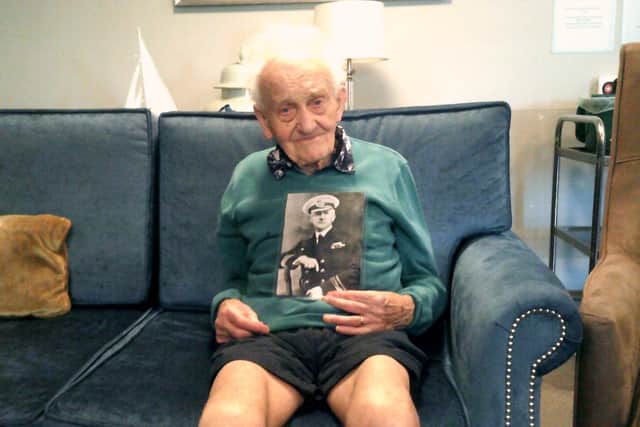 John Rostron with a photo of his grandfather, Sir Arthur Rostron.