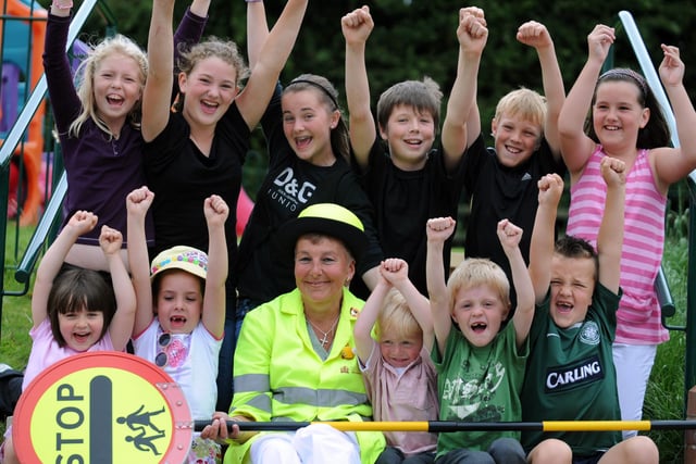 Pictured is Debbie Williams voted Barnsley's favourite lollipop lady in 2008 with pupils from her school Royston Summer Field Junior & Primary School.
