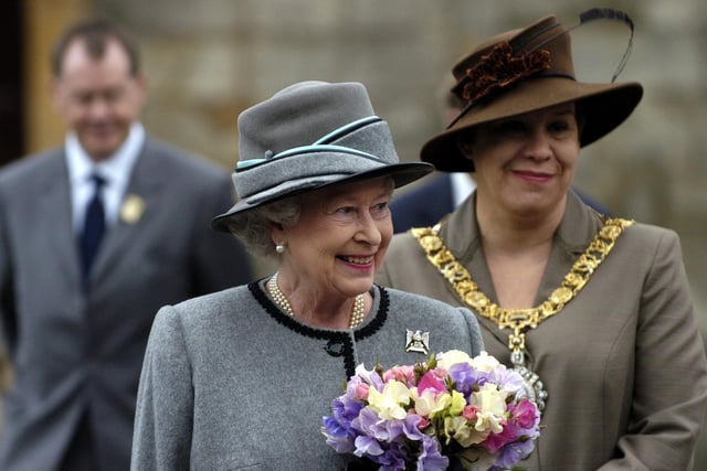 Her Majesty the Queen after receiving the keys of the city of Edinburgh in June 2004. A four-year-old girl from Prestonfield, Edinburgh, presented the Queen with flowers at the ceremony of the keys.