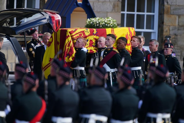 RETRANSMITTING AMENDING BYLINE Royal guards carry Queen Elizabeth II's coffin at the start of the procession from the Palace of Holyroodhouse to St Giles' Cathedral, Edinburgh. Picture date: Monday September 12, 2022.