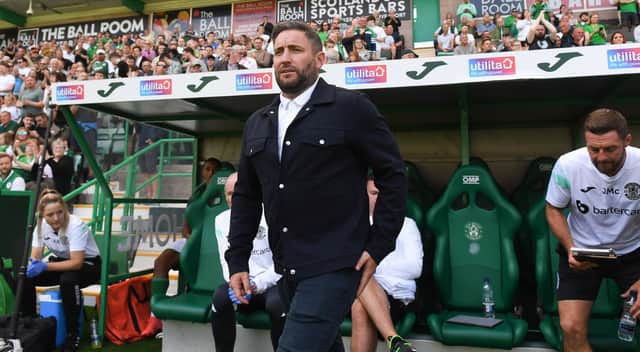 Lee Johnson takes his place in the Hibs dugout ahead of the Premier Sports Cup group match against Clyde