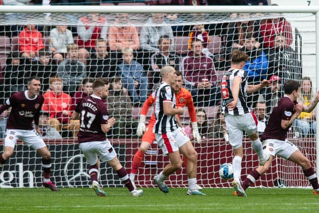 A helpless Hearts defence watch on as Mark O'Hara's shot is deflected into the back of the net off Alex Gogic. Picture: SNS