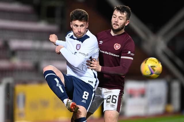 Craig Halkett battles for possession with Arbroath substitute Michael McKenna. Picture: SNS