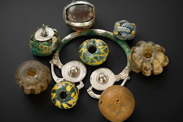 A collection of curios, including beads and pendants, found within the silver-gilt vessel. PIC: NMS.