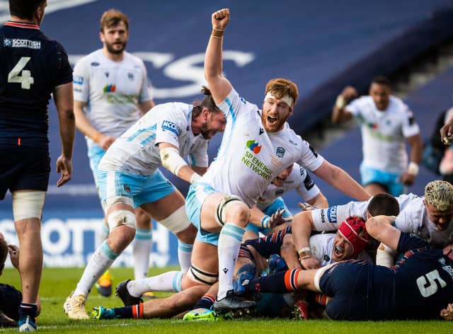 Rob Harley lifts his arm in celebration as Glasgow Warriors hooker George Turner forces his way over for a try. Picture: Ross MacDonald/SNS