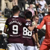 Lawrence Shankland and Zander Clark shake hands at full-time after Hearts came back to earn a point. Picture: SNS