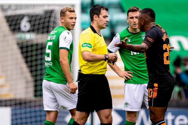 Hibs defenders Ryan Porteous and Paul Hanlon look on as Rangers striker Alfredo Morelos argues with referee Don Robertson. (Photo by Craig Williamson / SNS Group)