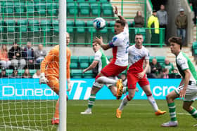 Paul Hanlon scores for Hibs with a header in injury time. Picture: SNS