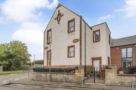 The flat features sociable open-plan living, a high-quality kitchen and bathroom, and tall windows that give way to great views of the Pentland Hills.