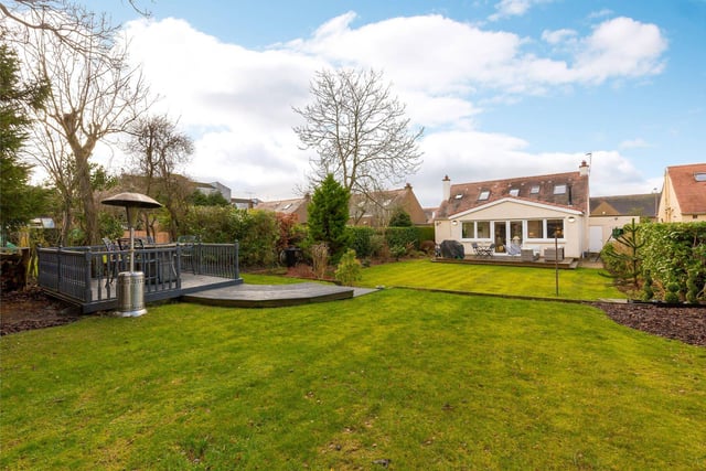 The sunny rear garden offers plenty of space to run around and two large, decked areas provide the perfect entertaining space. Well stocked borders surround an expanse of lawn and mature trees ensure privacy during the summer months.