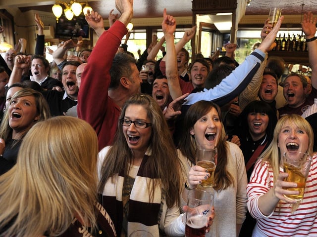 Hearts fans celebrate Hearts win over Hibs in the Scottish Cup Final in 2012 at the Athletic Arms pub in Gorgie.
