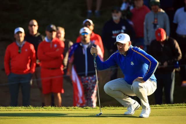 On his record-equalling 11th appearance in a Ryder Cup, Lee Westwood lines up a putt on the first green. Picture: Mike Ehrmann/Getty Images.