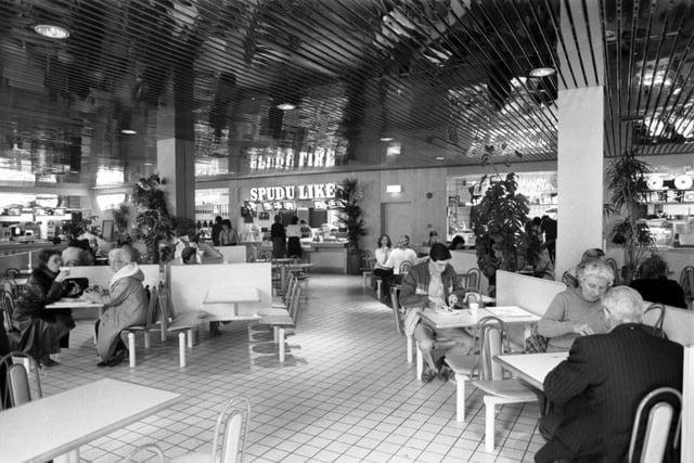 Shoppers in the Food Court (Spud U Like baked potato shop in background) of the newly-opened Cameron Toll shopping centre in Edinburgh, April 1985.