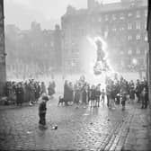 To mark Victoria Day in May 1952, locals gathered around a bonfire on the Grassmarket.