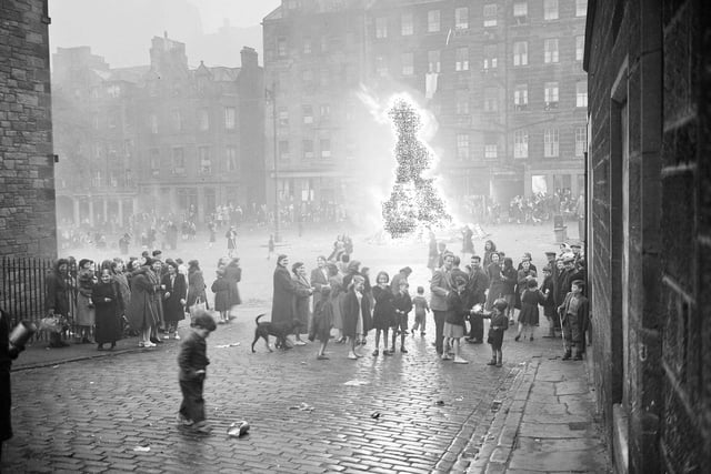 To mark Victoria Day in May 1952, locals gathered around a bonfire on the Grassmarket.