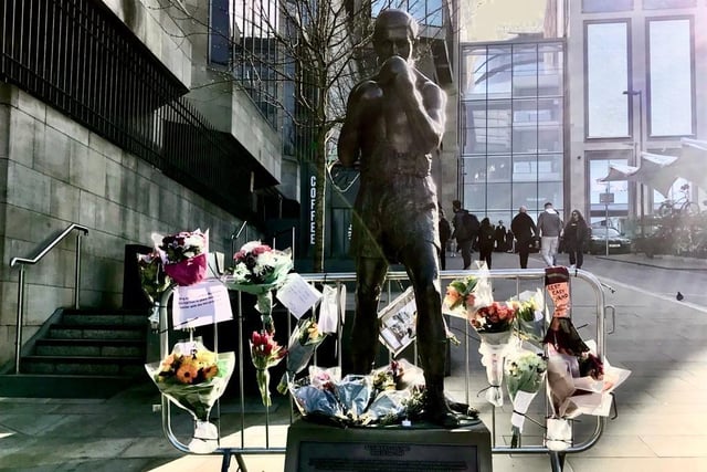 Floral tributes have been left at the statue of Edinburgh boxing legend Ken Buchanan outside the St James Quarter.