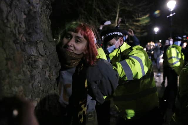 A woman is arrested during a vigil for Sarah Everard on Clapham Common on March 13, 2021 in London, United Kingdom. (Photo by Hollie Adams/Getty Images)