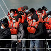 A group of people thought to be migrants are brought in to Dover, Kent, following a small boat incident in the Channel. Under a scheme designed to crack down on migrants landing on British shores after crossing the Channel in small boats, the UK intends to provide those deemed to have arrived unlawfully with a one-way ticket to Rwanda. Picture date: Friday April 15, 2022.