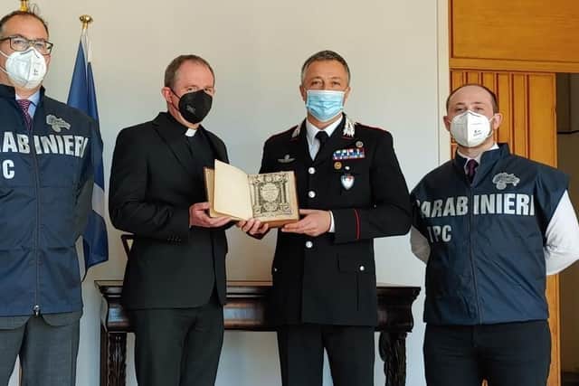 Carabinieri  officers formally hand over Cardinal Bellerine's 1605 book of sermons to the Scots College in Rome