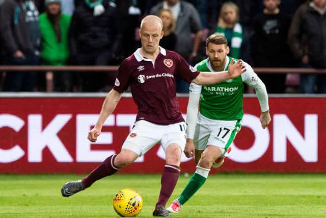 Hibernian's Martin Boyle competes with Hearts' Steven Naismith. Both could be involved at Hampden.