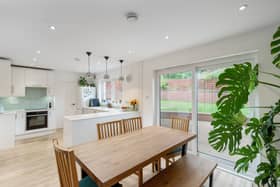 The bright open plan kitchen / dining room and utility room with direct access to the enclosed rear garden and decking area.