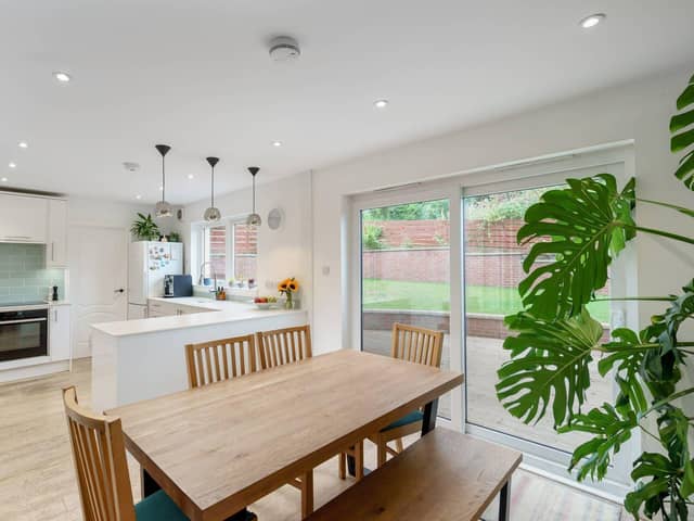 The bright open plan kitchen / dining room and utility room with direct access to the enclosed rear garden and decking area.