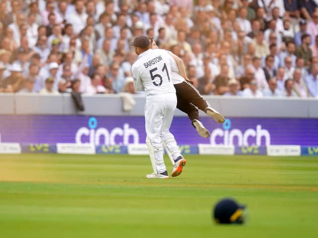 England's Johnny Bairstow carrying a Just Stop Oil protestor off the pitch  during day one of the second Ashes test match at Lord's, London. Adam Davy/PA Wire.