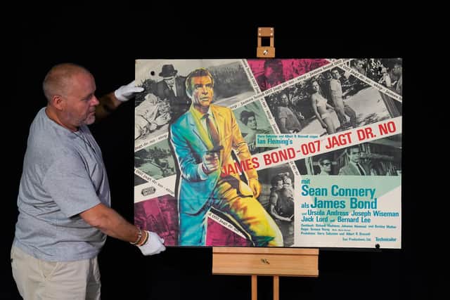 Poster consultant Mark Hochman adjusting a German A0 poster for the 1962 James Bond film 'Dr No' featuring Sean Connery as James Bond